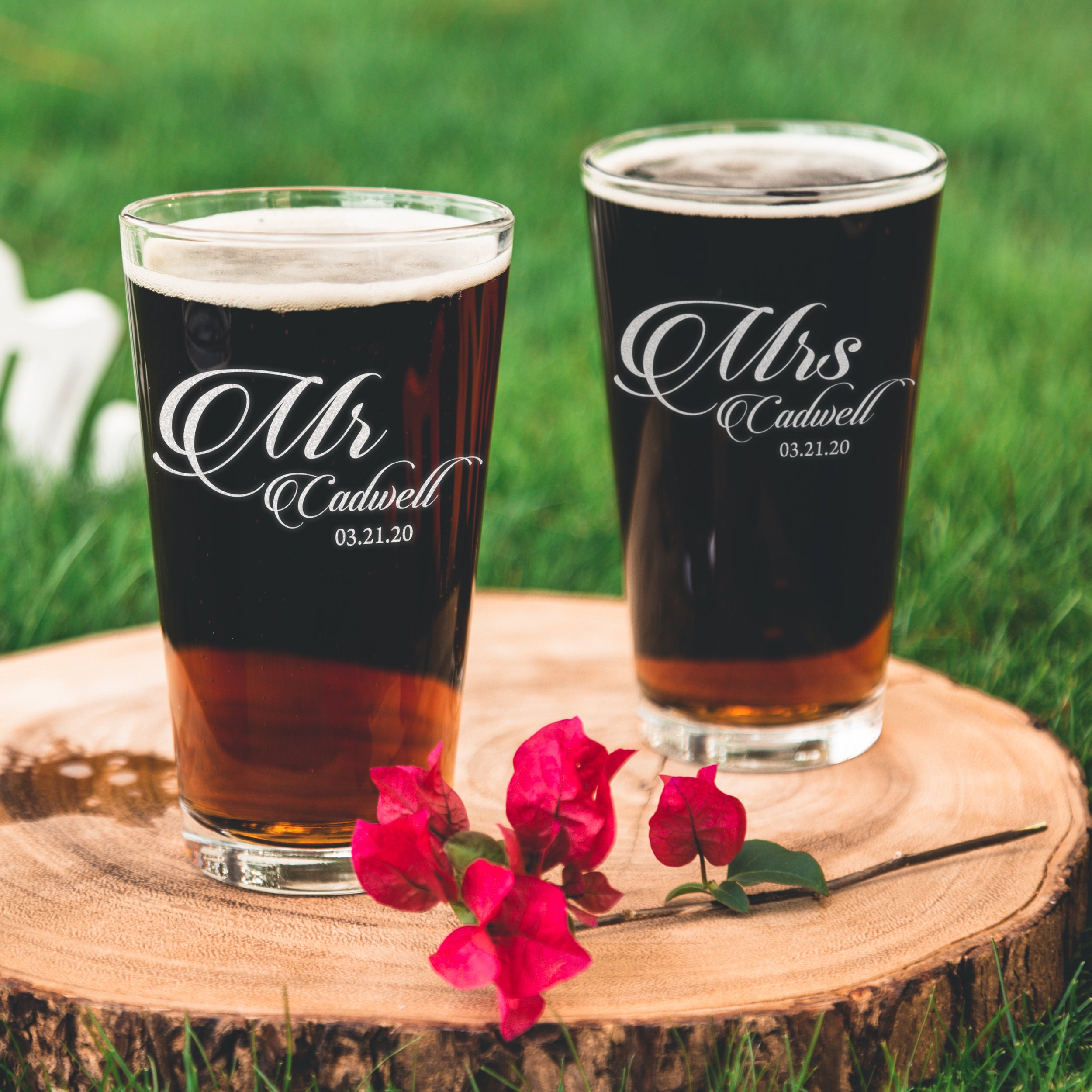 Pint glass on a table. The glass has an etched design centered on the front. The design is "Mr" in cursive and below it is "Cadwell" in cursive then below that is "03.21.20". The design is centered and can be "Mr" or "Mrs".