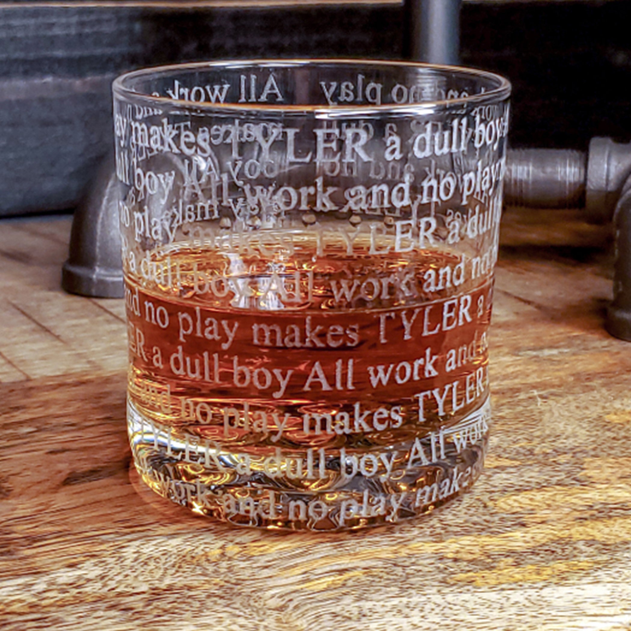 Personalizable whiskey glass with Stephan King Shining quote. Glass has engraved text ALL WORK AND NO PLAY MAKES TYLER A DULL BOY repeated and wrapped all the way around the glass. 